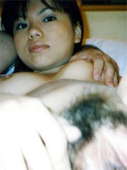 Sweet Asian teen is showing her tight and hairy pussy on bed