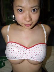 Busty Asian babe is posing topless and naked